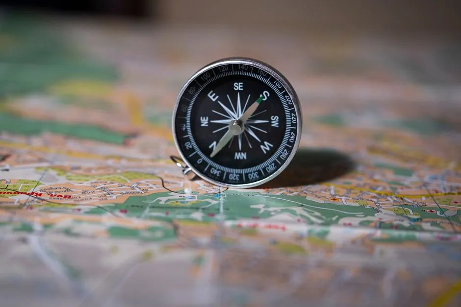 Compass resting on a paper map, illustrative photo representing data verification