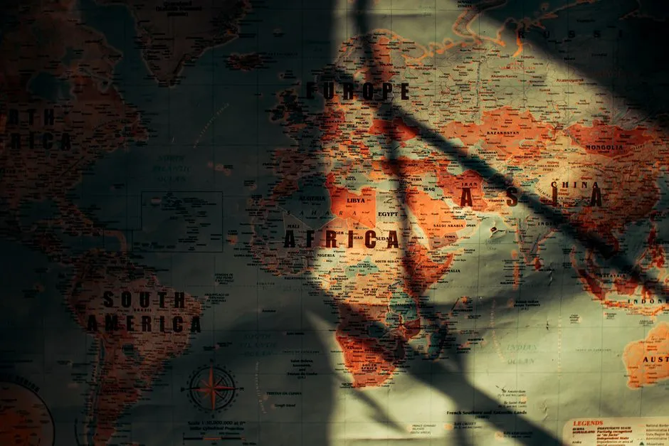 Sunlit paper world map showing continents and oceans, illustrative photo
